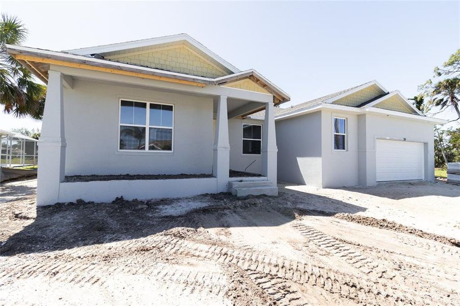 Front exterior of a new home in , Rotonda West, FL, highlighting curb appeal (Image 1).