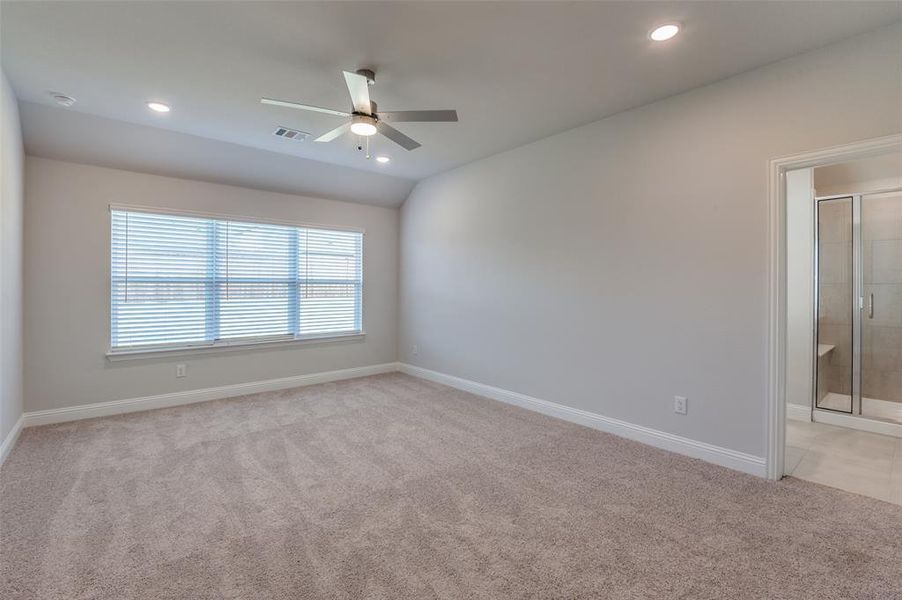 Carpeted room featuring a ceiling fan, recessed lighting, and a window with blinds