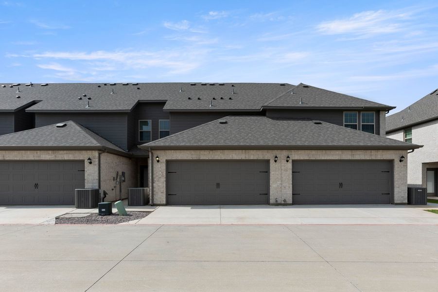 Front exterior of a new home in Sanger Circle – Townhomes, Sanger, TX, highlighting curb appeal (Image 27). Front exterior of a new home in Sanger Circle – Townhomes, Sanger, TX, highlighting curb appeal (Image 27).
