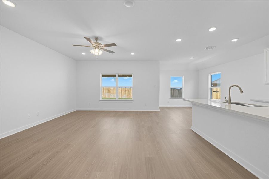 Unfurnished living room featuring recessed lighting, light wood-style floors, and a ceiling fan