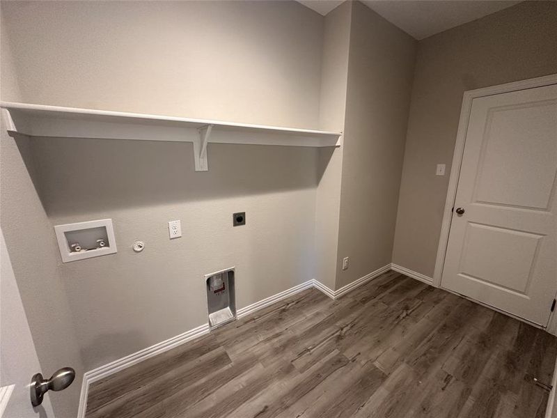 Washroom featuring hookup for a washing machine, hookup for an electric dryer, dark hardwood / wood-style floors, and hookup for a gas dryer