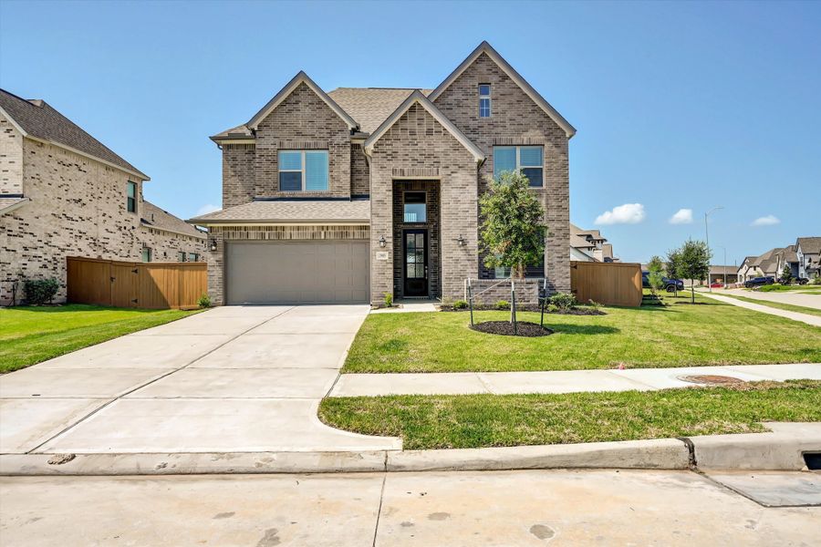 Front exterior of a new home in Sunterra 50s, Katy, TX, highlighting curb appeal (Image 2). Front exterior of a new home in Sunterra 50s, Katy, TX, highlighting curb appeal (Image 2).