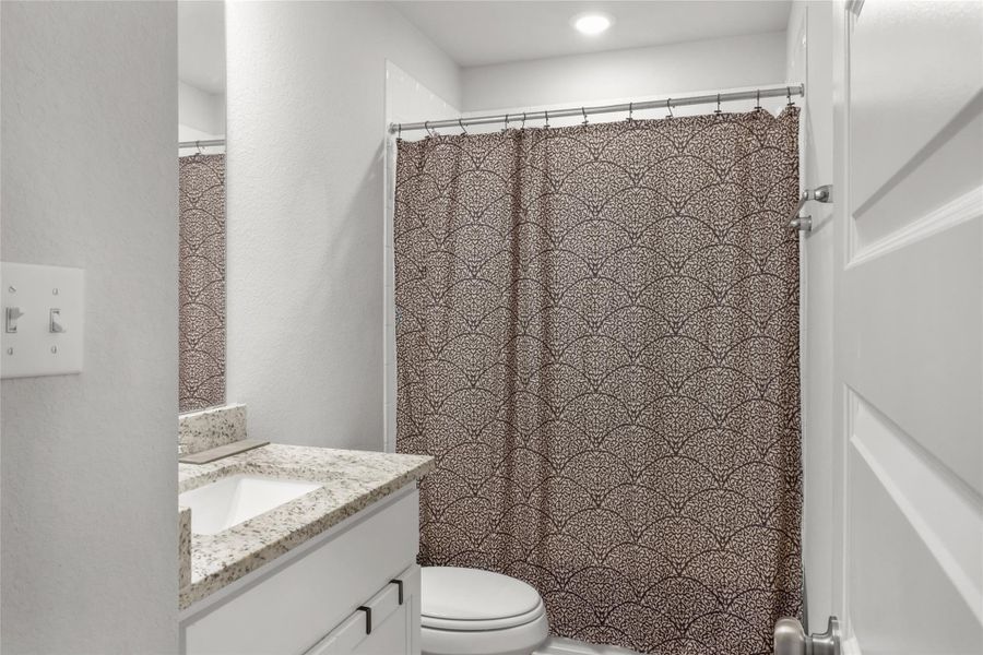 Bathroom with vanity and a shower with curtain
