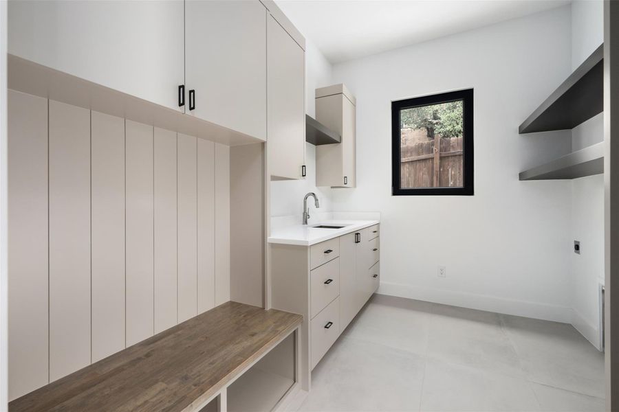 Mud room/laundry room with bench cubbies, cabinets, sink and space for refrigerator. Mud room/laundry room with bench cubbies, cabinets, sink and space for refrigerator.