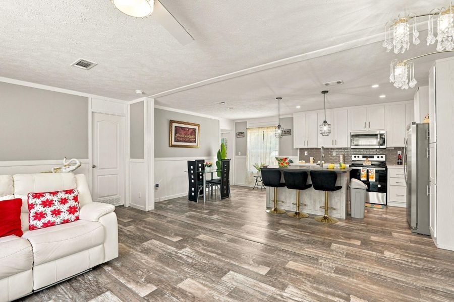 An open floor plan connects the living space directly to the kitchen and dining area.