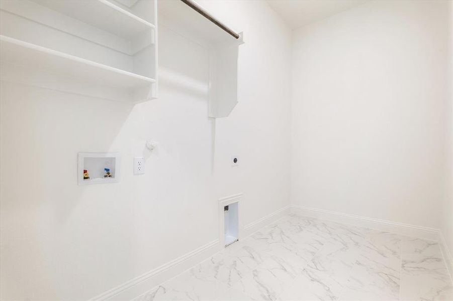 Laundry room featuring  tile flooring, washer hookup