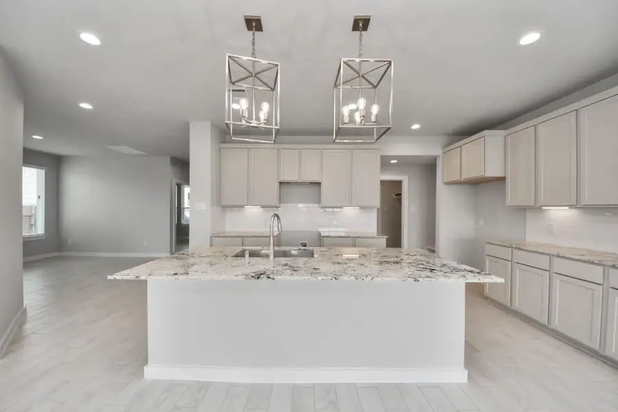 This kitchen is by far any chef’s dream! This spacious kitchen features high ceilings, light stained wood cabinets, granite countertop, SS appliances, modern tile backsplash, recessed lighting, extended counter space, granite kitchen island with double sink, and space for breakfast bar, and a walk-in pantry all overlooking your huge family room. Sample photo of completed home with similar floor plan. Actual colors and selections may vary.
