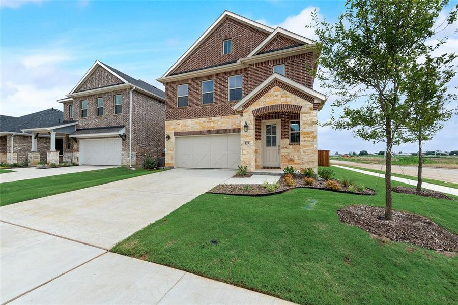 Front exterior of a new home in Spiritas Ranch, Little Elm, TX, highlighting curb appeal (Image 2).