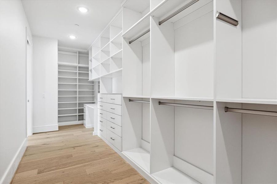 Upgraded custom primary closet with built-in shelves, hanging racks, and clothing drawers, and velvet-lined jewelry drawers.  Luxurious!