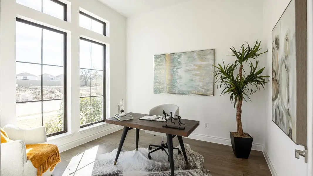 Office area featuring baseboards and dark wood-style flooring