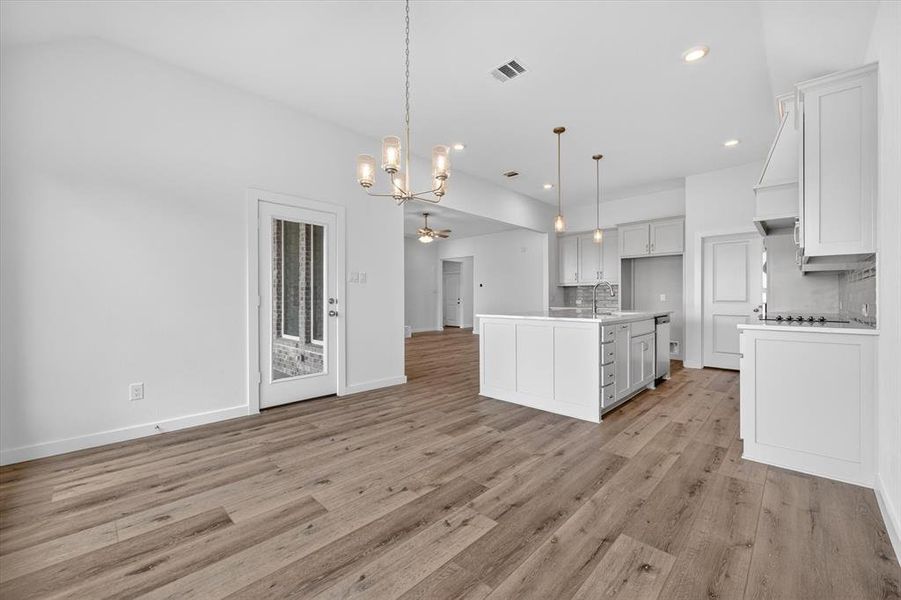 Spacious kitchen and dining area with wood-finish flooring