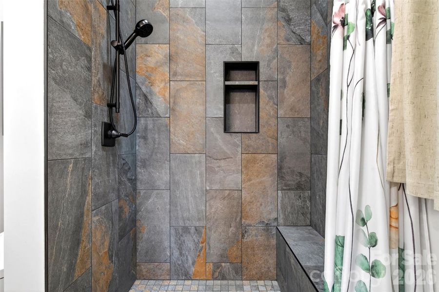 Walk-in tile shower with a seat built with Schluter shower water proofing system in this and all showers in the home.