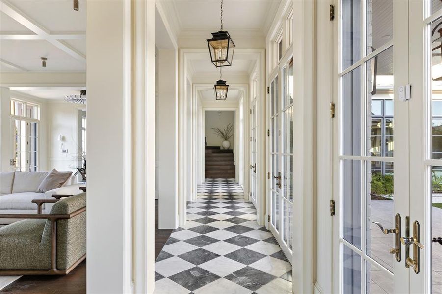 Corridor featuring french doors, coffered ceiling, ornamental molding, and beam ceiling Corridor featuring french doors, coffered ceiling, ornamental molding, and beam ceiling