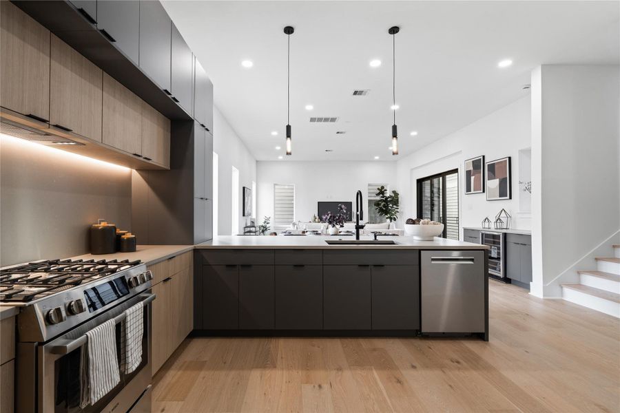 Every detail in this chef’s kitchen has been dialed in with purpose—from the soft under-cabinet lighting that highlights the textured stone backsplash to the precision of Bosch appliances integrated seamlessly into the cabinetry. The matte black fixtures echo the home’s modern edge, while warm oak tones keep the space grounded. It’s a design that doesn’t ask forattention—it earns it.
