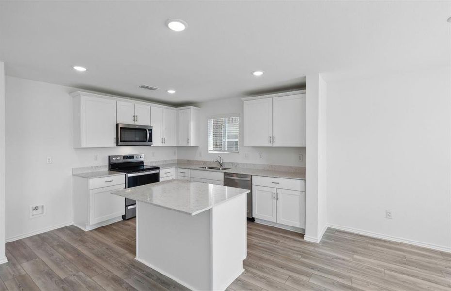 Ample cabinet space in kitchen with large island *real home pictured