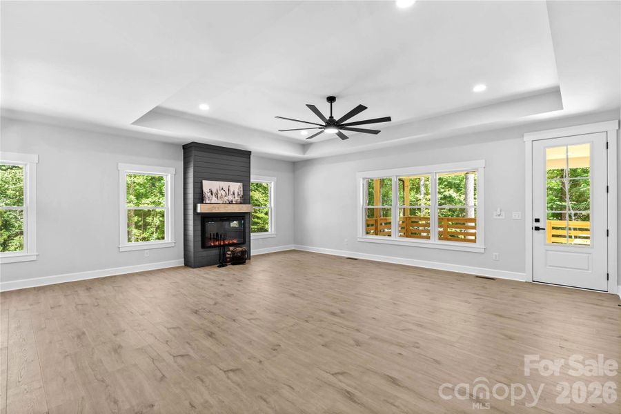 Shows how large the Den is. Shiplap fireplace wall included with home.