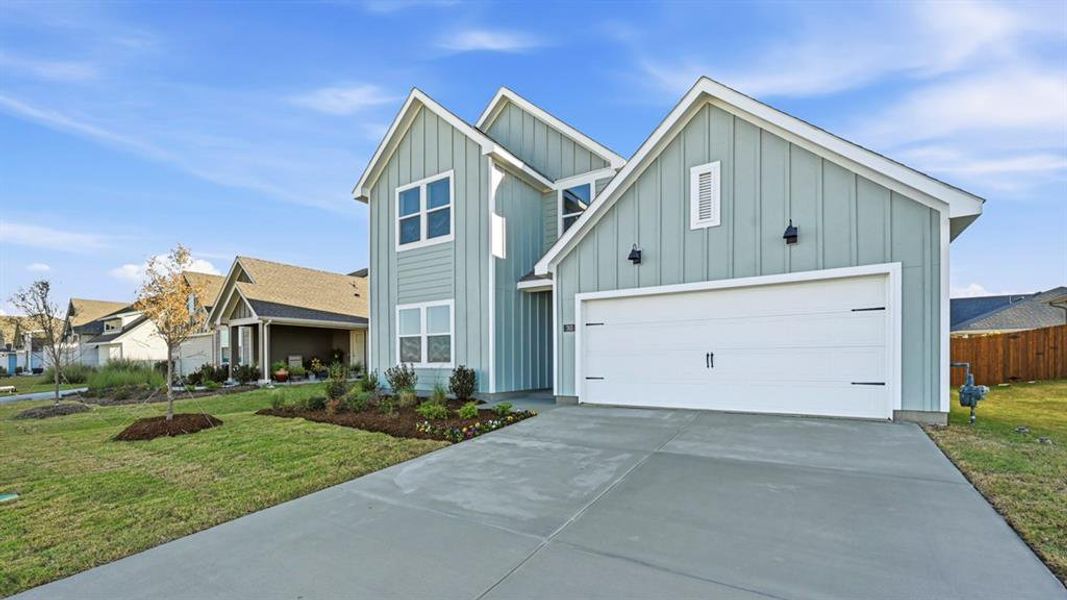 View of front of house featuring board and batten siding, concrete driveway, and a garage View of front of house featuring board and batten siding, concrete driveway, and a garage