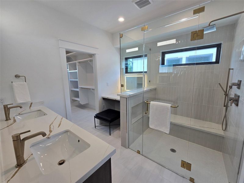 Bathroom with a shower stall, visible vents, and a sink Bathroom with a shower stall, visible vents, and a sink