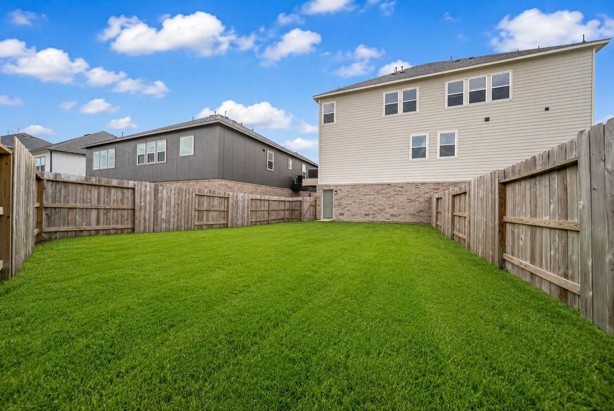 Spacious fenced backyard.