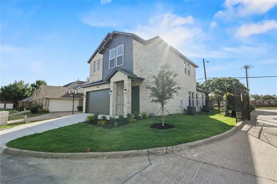 View of front of house with brick siding, concrete driveway, and an attached garage