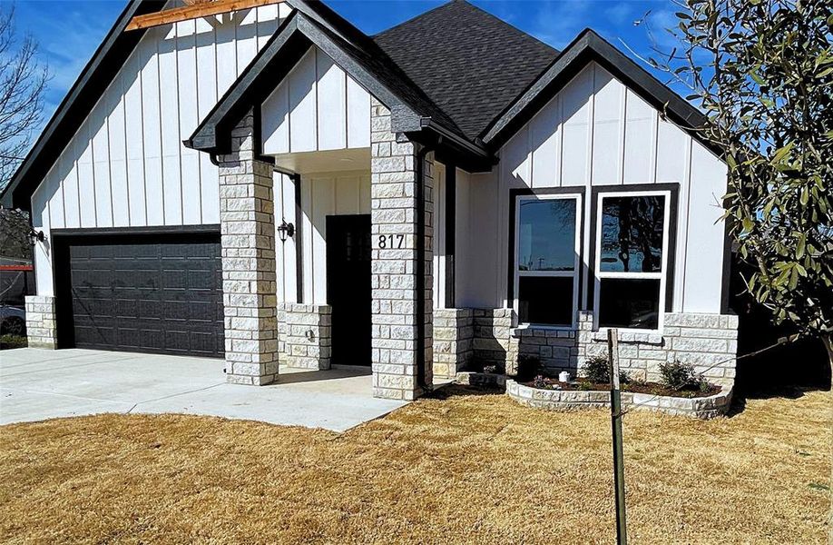 Modern style home featuring a front lawn