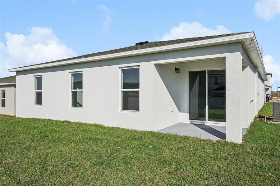 Exterior details and patio area of a home in The Enclave at Scenic Terrace, Haines City (Image 10).