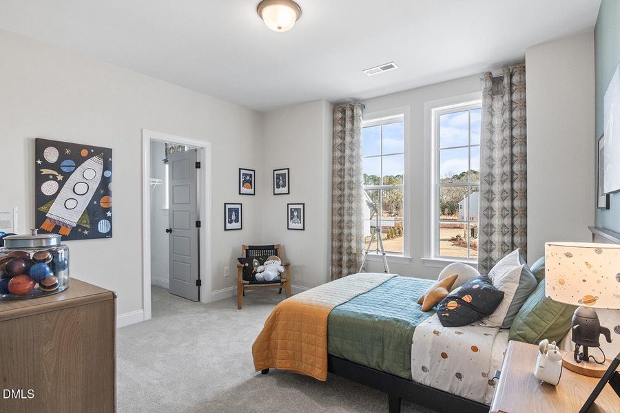 secondary bedroom with walk-in closet