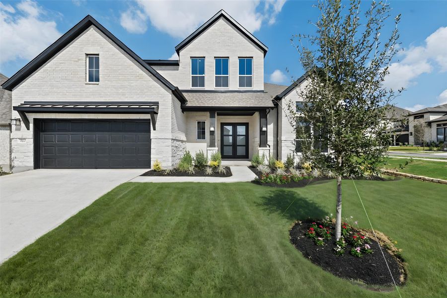 View of front of home with a front lawn and driveway View of front of home with a front lawn and driveway