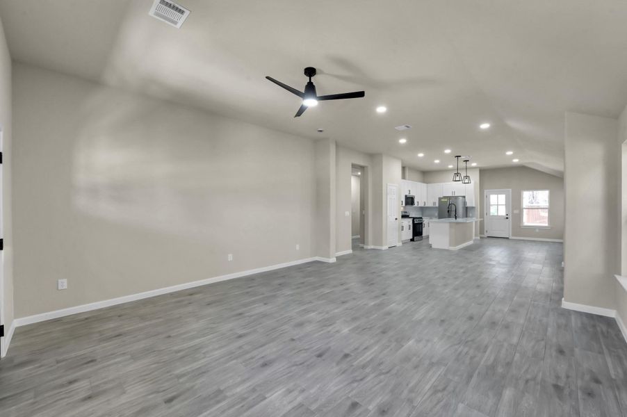 Experience effortless flow from the grand living area into the gourmet kitchen, anchored by a large center island—perfect for casual dining or hosting friends.