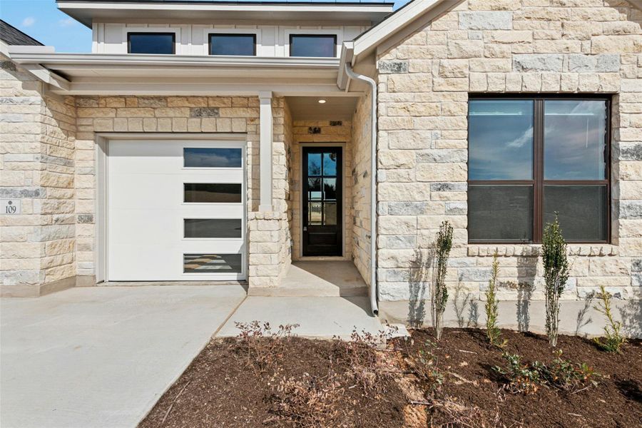 View of exterior entry with stone siding