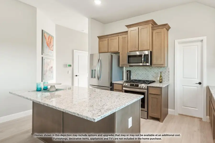 Kitchen with granite island, tan cabinets, stainless steel appliances, and tiled backsplash Kitchen with granite island, tan cabinets, stainless steel appliances, and tiled backsplash