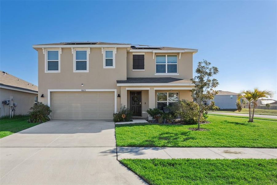 Front exterior of a new home in Zephyr Ridge, Zephyrhills, FL, highlighting curb appeal (Image 23). Front exterior of a new home in Zephyr Ridge, Zephyrhills, FL, highlighting curb appeal (Image 23).