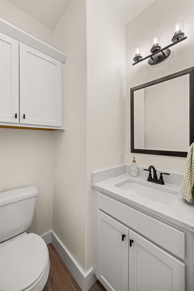 A well-appointed half-bath offers convenience with elegant fixtures and ample storage.