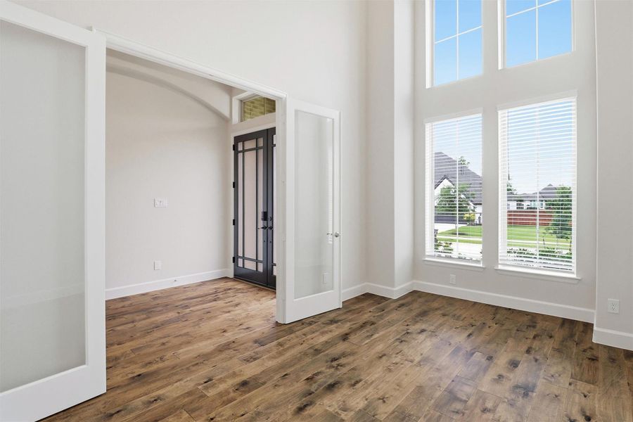 Upon entering the home office will be on your left. French door access, plus 11 foot ceilings and large windows allow light to fill the space.