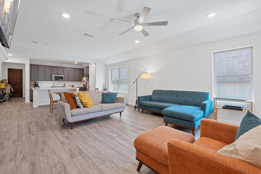 Living area featuring recessed lighting, light wood-type flooring, and a ceiling fan Living area featuring recessed lighting, light wood-type flooring, and a ceiling fan