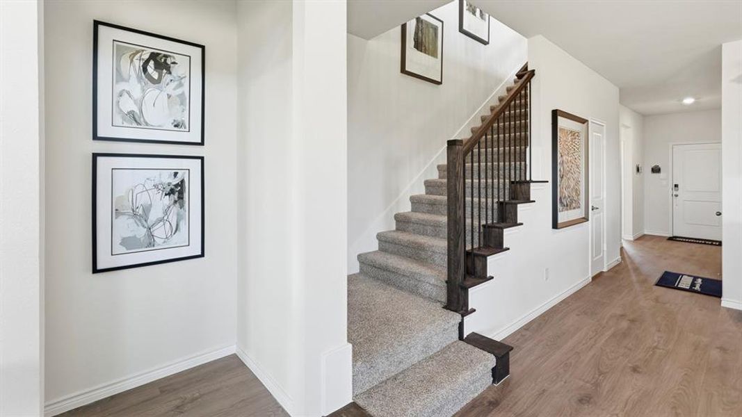 Stairway featuring baseboards and wood finished floors