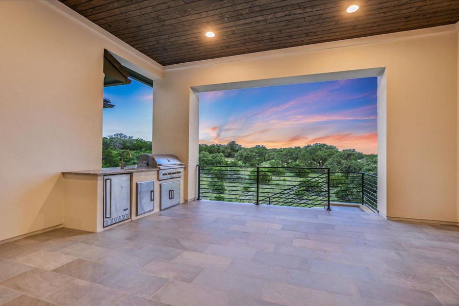 Patio terrace at dusk with area for grilling and a sink