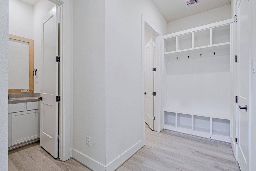 Mudroom-style built-ins provide the perfect drop zone for bags and shoes
