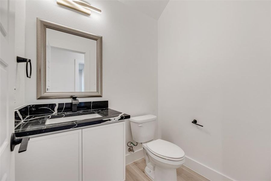 Half bath with vanity and light wood-style flooring Half bath with vanity and light wood-style flooring