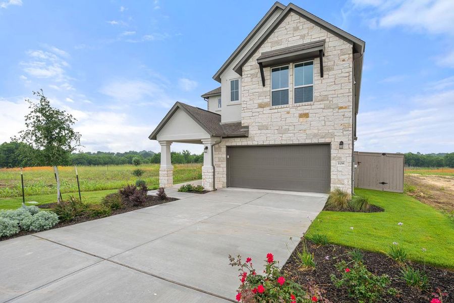 Front exterior of a new home in Flora, Hutto, TX, highlighting curb appeal (Image 1). Front exterior of a new home in Flora, Hutto, TX, highlighting curb appeal (Image 1).