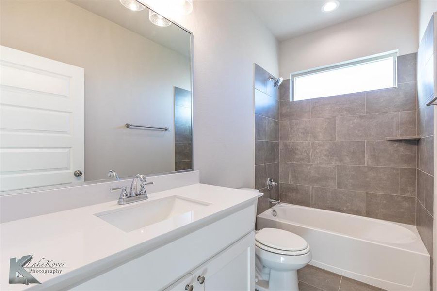 Empty room featuring light colored carpet and ceiling fan