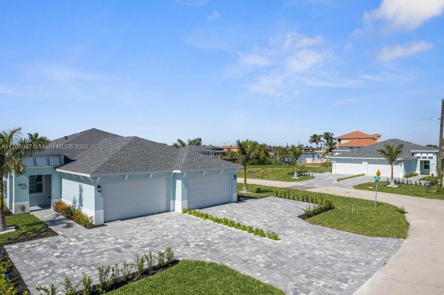 Front exterior of a new home in , Cape Coral, FL, highlighting curb appeal (Image 17). Front exterior of a new home in , Cape Coral, FL, highlighting curb appeal (Image 17).