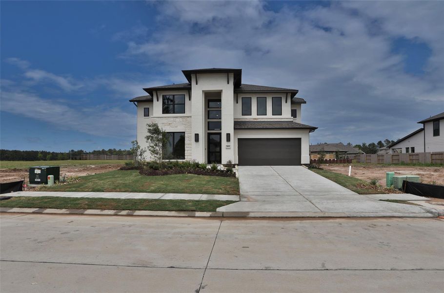 Front exterior of a new home in Artavia 55' - Valencia, Conroe, TX, highlighting curb appeal (Image 15). Front exterior of a new home in Artavia 55' - Valencia, Conroe, TX, highlighting curb appeal (Image 15).