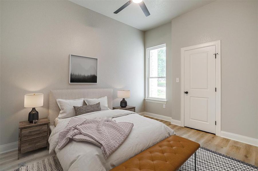 Bedroom with baseboards, ceiling fan, and light wood-style floors Bedroom with baseboards, ceiling fan, and light wood-style floors