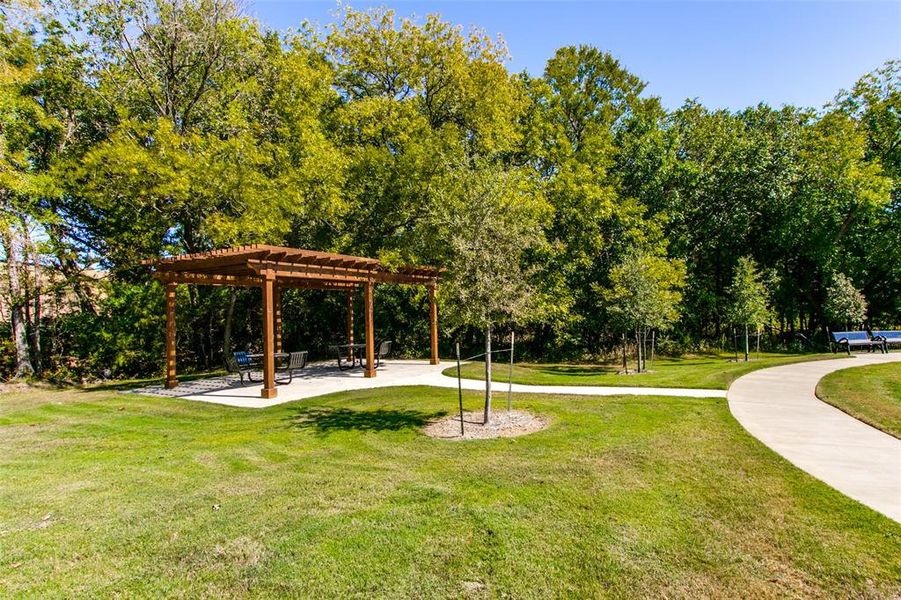 Surrounding community with a pergola, a patio, and a yard