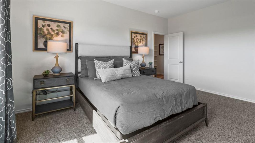 Bedroom featuring carpet floors and baseboards