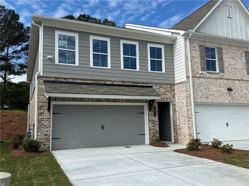 Front exterior of a new home in Wildwood Place, Powder Springs, GA, highlighting curb appeal (Image 12).