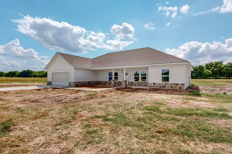 Back of property featuring a garage