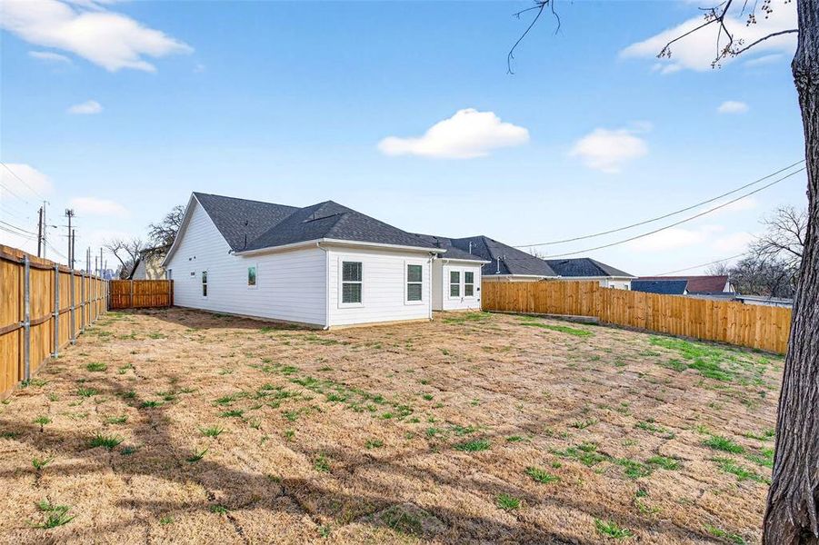 Back of property featuring a fenced backyard