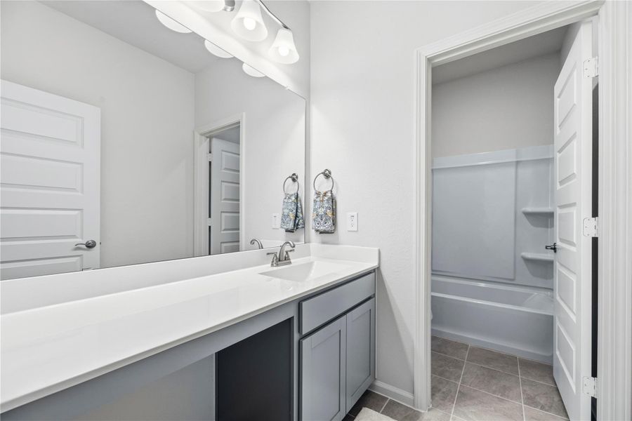 Second upstairs bathroom offers a large vanity and tub/shower combination. Second upstairs bathroom offers a large vanity and tub/shower combination.